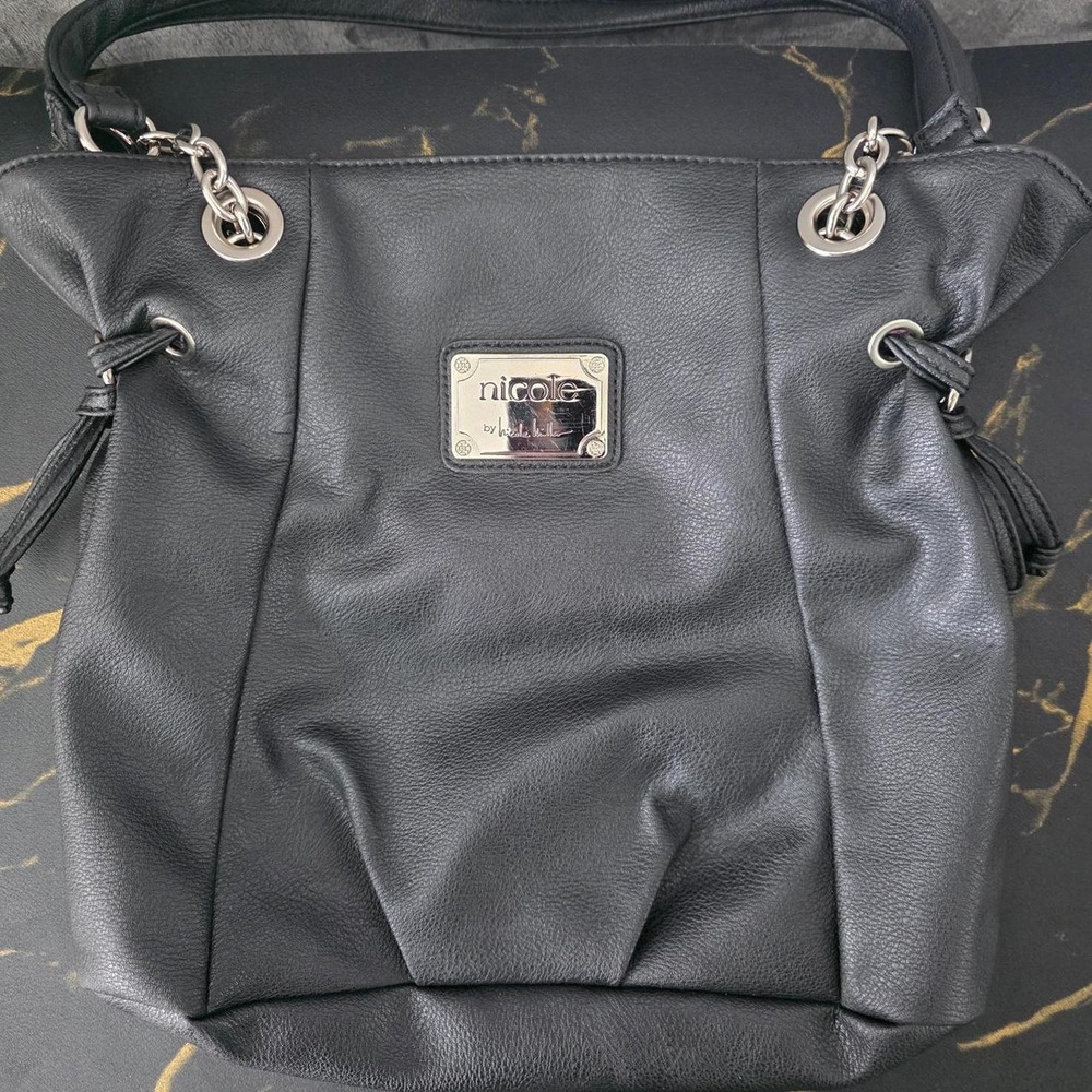 Nicole Miller black leather tote bag with silver hardware and tassels